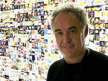 Ferran Adrià in front of his wall of photos of El Bulli dishes                                                                (Robert Camuto)