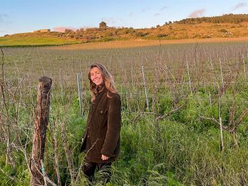 Serra Ferdinandea project manager Cecilia Carbone shows off the biodynamically farmed estate in winter, when grasses are left to grow high around the vines to contribute to soil health.                                                                (Robert Camuto)